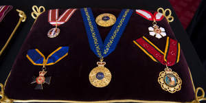 The insignia for Philip’s Knight of the Order of Australia rests on the centre of the cushion.