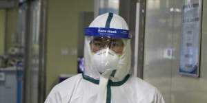 Medical workers treat patients in the isolated intensive care unit at a hospital in Wuhan in February 2020. 