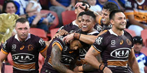 The Broncos mob try-scorer Jamayne Isaako during their win over the Bulldogs.