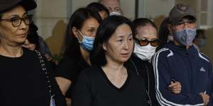  Stanley Ho's daughter,Pansy (centre),speaks alongside other family members outside a hospital in Hong Kong on Tuesday.