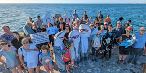 A “community photoshoot” held Thursday night to promote responsible fishing at Ammunition Jetty,Coogee. 