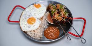 Tapsilog:beef skewers,eggs,garlic rice,banana ketchup and pickles.