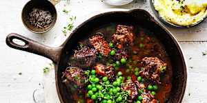 Neil Perry's red wine braised beef brisket cooked in a cast iron pan.