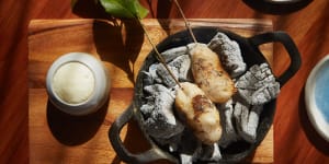 Potato damper on eucalyptus skewers,cooking on hot coals at your table.