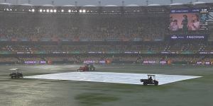 The Gabba outfield was under water at one point as drenching rain forced groundsmen to put covers on the pitch.