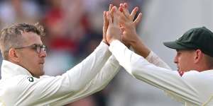 Todd Murphy celebrates his dismissal of Joe Root in England’s second innings with teammate Marnus Labuschagne.