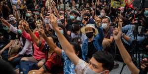 Anti-government protesters wave chopsticks as makeshift wands while they take part in a Harry Potter themed rally in Bangkok on Monday.