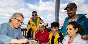 Mani Mirfeizi (far left) husband Hamid (in yellow jacket) and son Arshia (in red) with Rachele Hesari (right),husband Farzae and son Korosh,15 (in yellow) at Altona Beach on Australia Day.