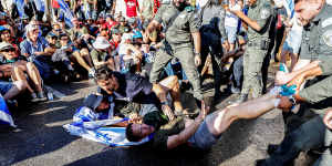 Israeli border police attempt to remove protesters from a road leading to the Knesset on Monday. 