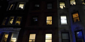 ir residence hall windows as members of the New York Police Department strategic response team move towards an entrance.