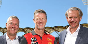 Damien Hardwick with Gold Coast chief executive Mark Evans and chairman Bob East.