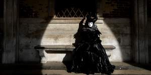 A woman in full costume for Venice Carnival,which was on Sunday cancelled due to the coronavirus outbreak.