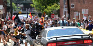 A vehicle drives into a group of protesters demonstrating against a white nationalist rally in Charlottesville.