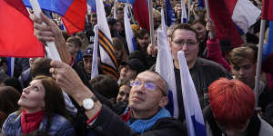 Demonstrators hold Russian state flags,flags with the letter Z,which has become a symbol of the Russian military,and a hashtag reading “We don’t abandon our own” during the action.
