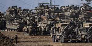 Israeli soldiers gather in a staging area near the border with Gaza Strip,in southern Israel.
