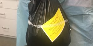 More than 200 COVID-19 swabs taken from St Basil's residents and staff were placed in a garbage bag and transported by taxi to the lab.