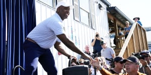 Republican presidential candidate Sen. Tim Scott greets audience members before speaking at a Fair-Side Chat at the Iowa Fair.