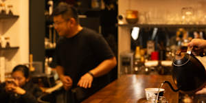 Cathy Zhang behind the counter at Ms. Cattea Tea Bar.