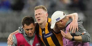 Crocked:James Sicily is assisted from the field during Hawthorn's loss to West Coast at Optus Stadium in Perth.
