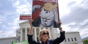 A protester outside the Supreme Court in April as the justices heard arguments over whether Donald Trump is immune from prosecution.
