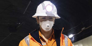 A worker walks through one of the interchange’s road tunnels which now has line markings. 