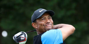 Tiger Woods three shots clear in Japan