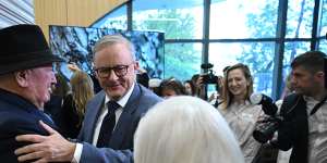 Prime Minister Anthony Albanese greets Lindsay Fox and his wife Paula before a tour of a new cancer centre in Melbourne on Friday.