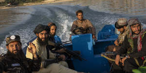 Taliban fighters enjoy a ride in the Qargha dam outside Kabul in September.