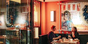 Theatrical art lines the walls. 