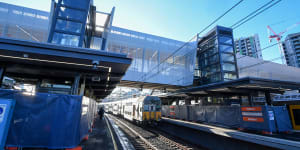 The new pedestrian bridge stretches across busy rail lines at Redfern station,providing lift access to platforms.