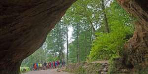 Cycling group at Latvia's Gutmanis Cave,the largest cave in the Baltics.