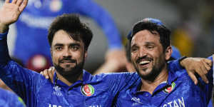 Afghanistan captain Rashid Khan (left) and teammate Gulbadin Naib celebrate after defeating Bangladesh.