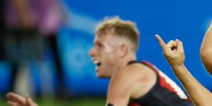 Tom Phillips celebrates a goal for the Hawks in their comeback win over Essendon.