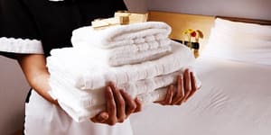 Hotel maid with towels.
