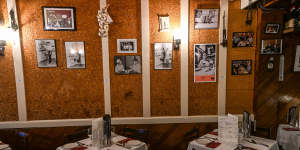 The dining room’s cork-lined walls are decorated with mementos and photographs.