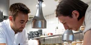 Executive chef Oliver Marlow (left) prepares a L’Enclume dish in the Bathers Pavilion kitchen.