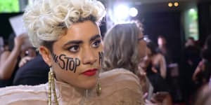 Australian singer Montaigne,on the ARIAs red carpet in Sydney,speaks about why she arrived with the words “Stop Adani” emblazoned across her cheeks.