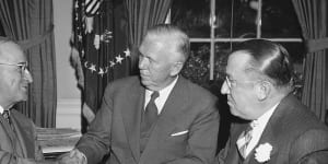 At the White House on October 3,1949,President Harry Truman,left,congratulates Gen. George Marshall (architect of the Marshall Plan) after the former secretary of state became chairman of the American Red Cross,succeeding Basil O’Connor,right. 
