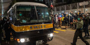 Supporters wave mobile phone lights as a Correctional Services bus leaves court following the sentencing of Joshua Wong,Agnes Chow and Ivan Lam.