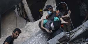 Palestinians evacuate wounded from a building destroyed in Israeli bombardment in Khan Younis,Gaza Strip.