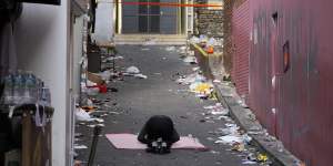 A man bows in the middle of the site of a deadly Halloween crowd crush in Seoul.