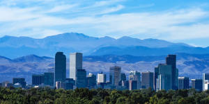 The Denver city skyline,downtown against the backdrop of the Rocky Mountains.