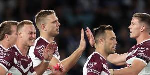 Manly celebrate a try against the Bulldogs on Friday night.