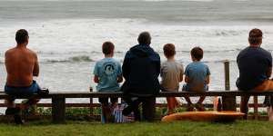 Kids enjoy a break in the weather at Byron bay before the arrival of Cyclone Alfred.