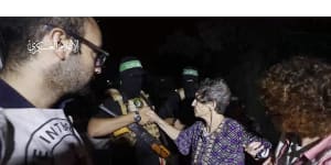 This image taken from video released by Al Qassam brigades on its Telegram channel,shows Yocheved Lifshitz,85,shaking hands and thanking a member of Hamas as she is released to the Red Cross.