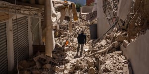 A man walks among the rubble in the town of Moulay Brahim in the High Atlas Mountains.