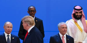 US President Donald Trump walks past Saudi Arabian Crown Prince Mohammad bin Salman,top right,Brazilian President Michel Temer,right,on his last G20 outing,in Buenos Aires last week.