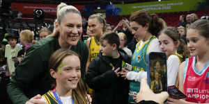 Lauren Jackson poses for a picture with a young fan at the FIBA Women’s World Cup in Sydney.