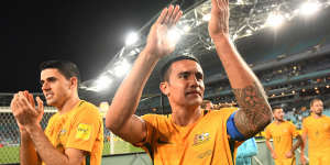 Australia's Tim Cahill (centre) and Tomas Rogic (left) applaud the crowd after their win over Syria at ANZ Stadium in October.