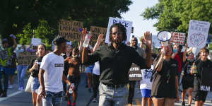 Joshua Benton leads protesters as they march down Main Street during a rally in Broken Arrow,Oklahoma. 